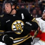 BOSTON, MASSACHUSETTS - OCTOBER 30: Charlie McAvoy #73 of the Boston Bruins commits an illegal check to the head against Oliver Ekman-Larsson #91 of the Florida Panthers during the third period at TD Garden on October 30, 2023 in Boston, Massachusetts.