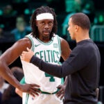 Boston Celtics head coach Joe Mazzulla, talks with guard Jrue Holiday.