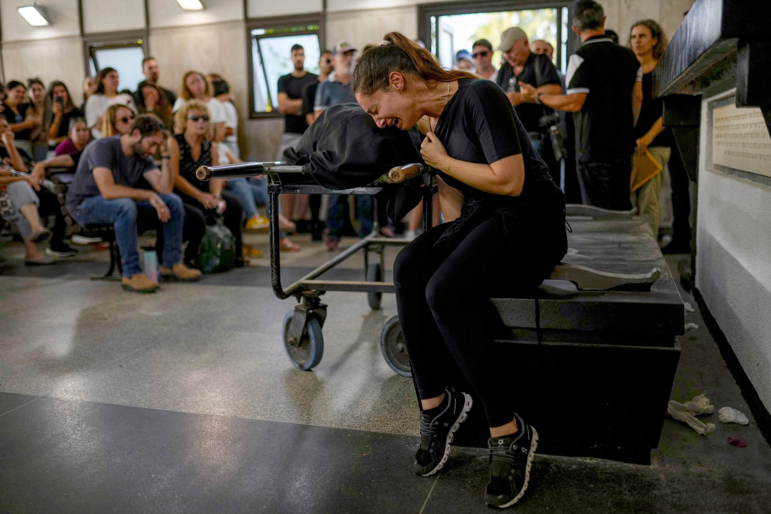 Mourners react beside the body of Mapal Adam, during her funeral in Tel Aviv, Israel.