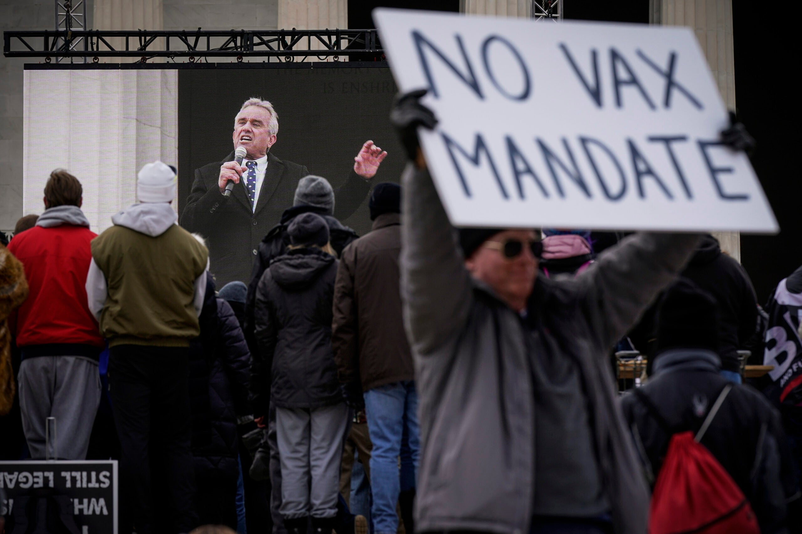 Robert F. Kennedy Jr., is broadcast on a large screen as he speaks during an anti-vaccine rally. 