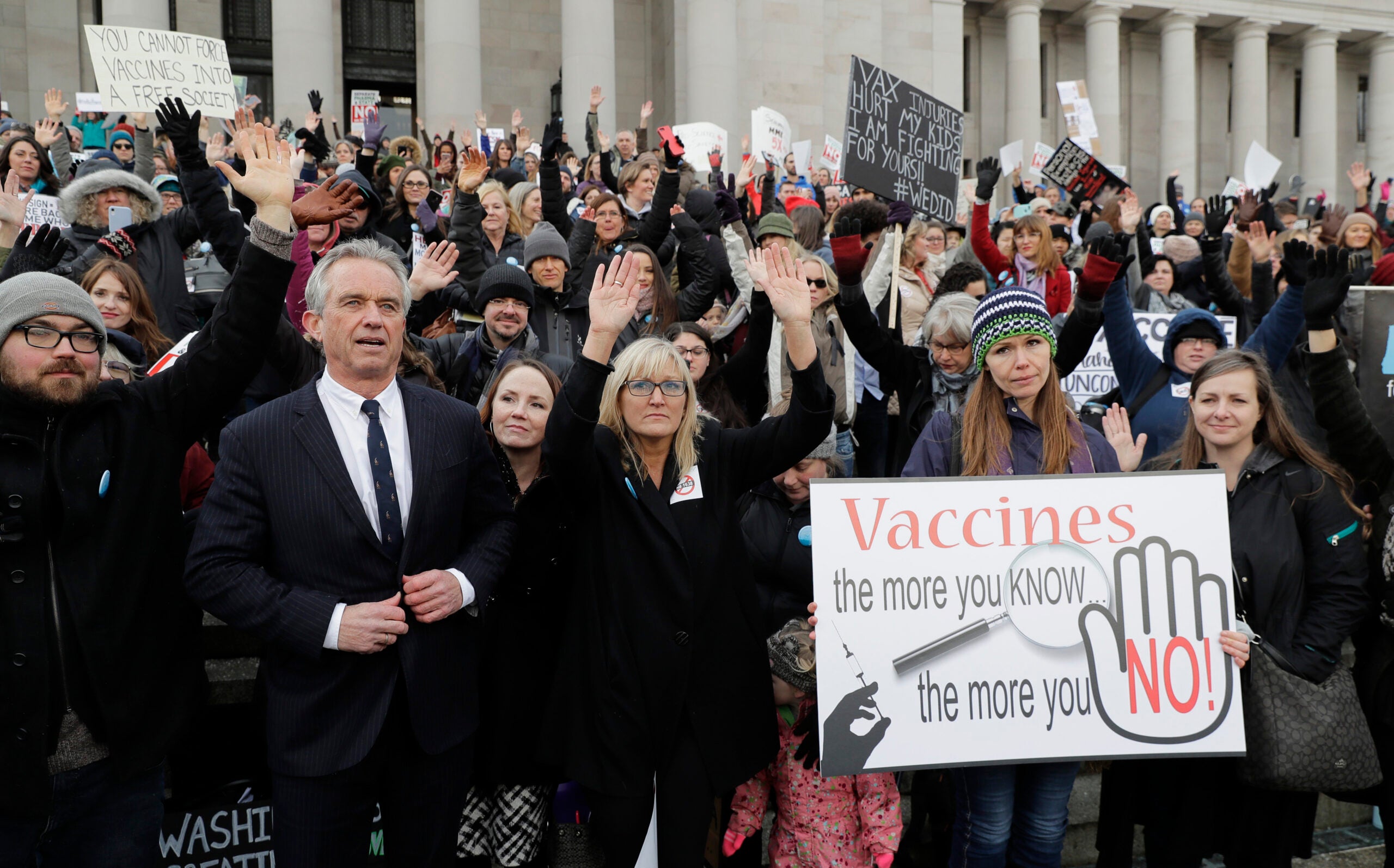 Robert F. Kennedy, Jr., left, stands with protesters at the Capitol in Olympia, Wash.