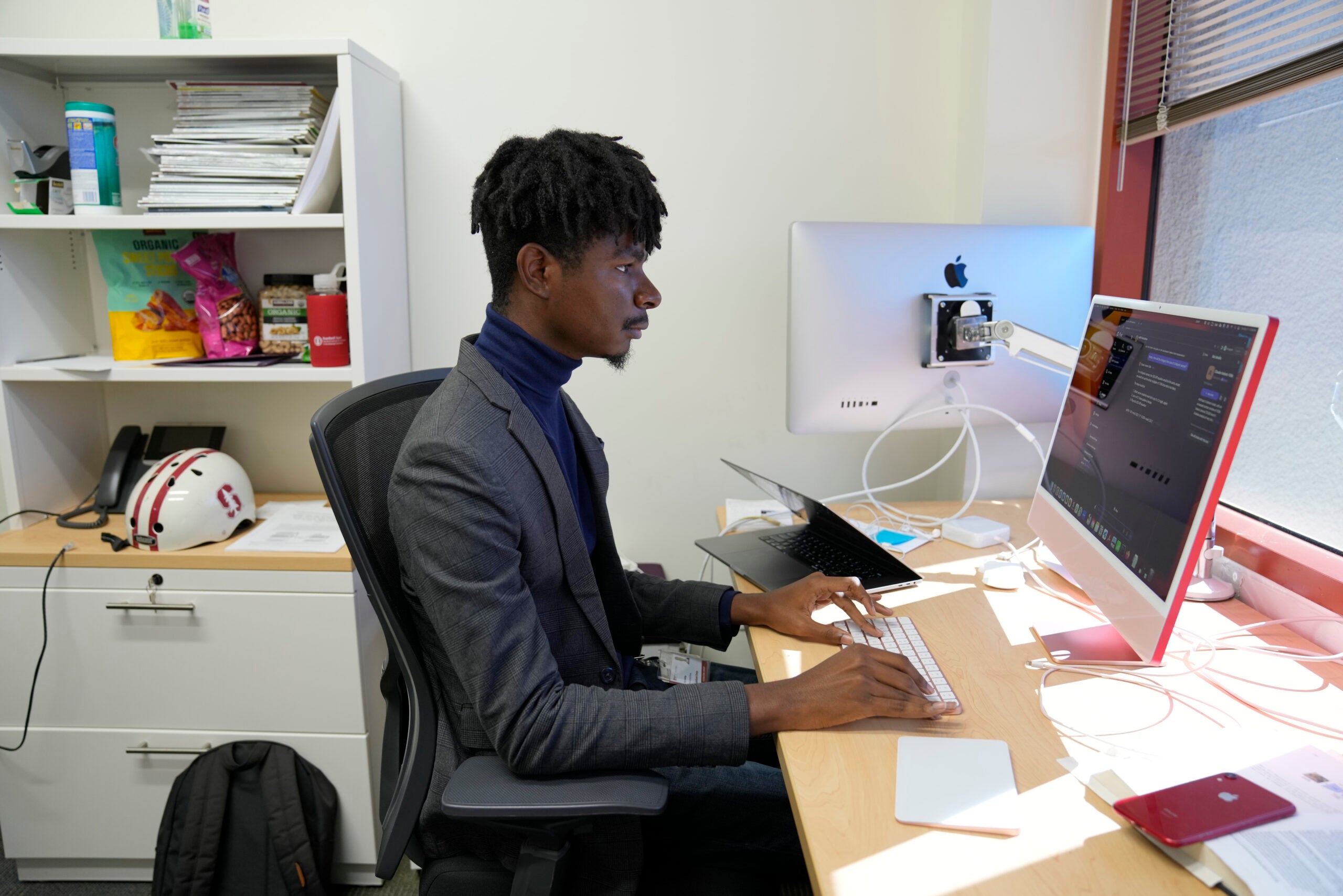 Post-doctoral researcher Tofunmi Omiye works in his office. 