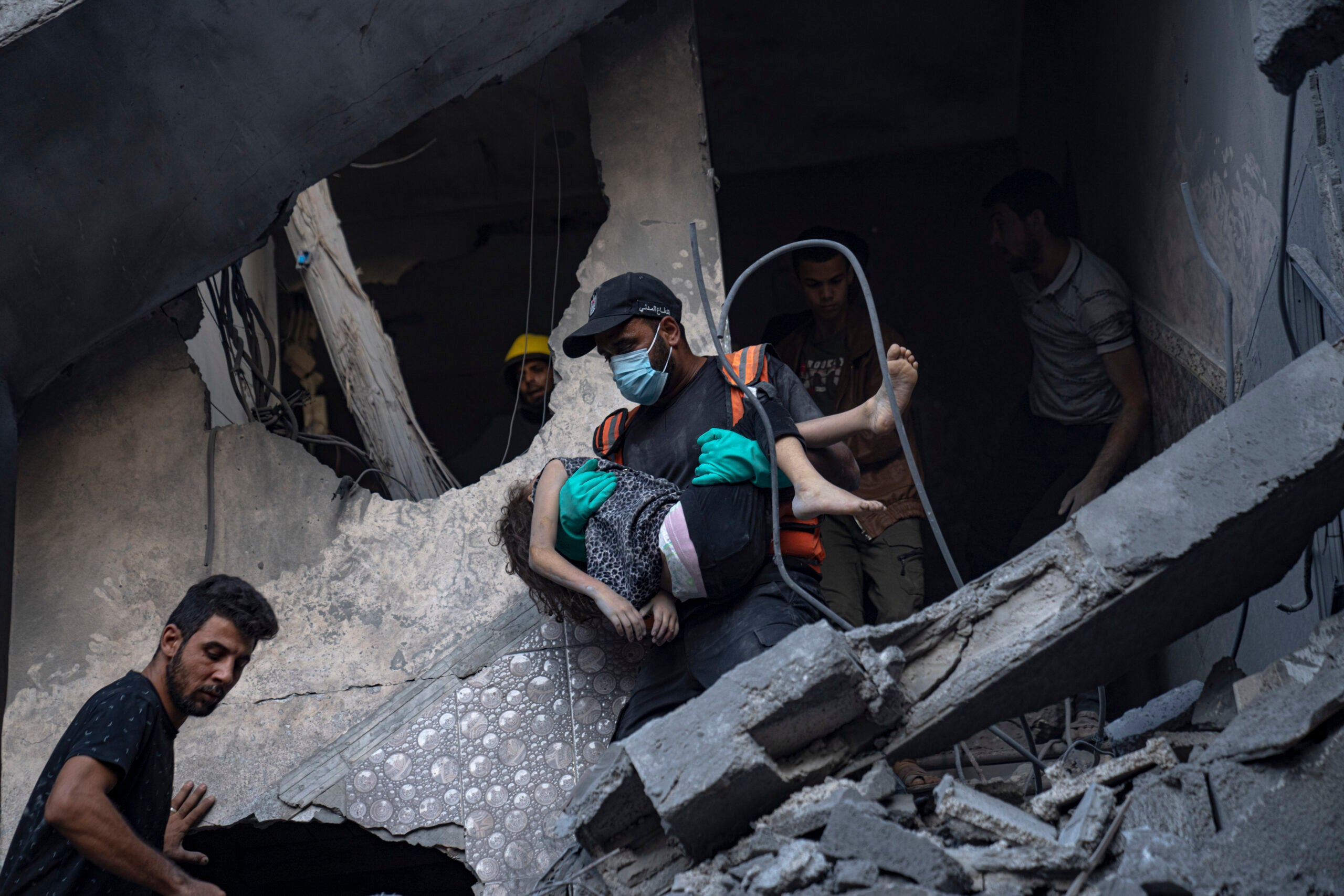 Palestinians evacuate wounded from a building destroyed in Israeli bombardment. 