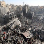Palestinians inspect the rubble of destroyed buildings following Israeli airstrikes on town of Khan Younis.