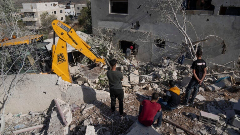 Palestinians inspect the demolished family home of Saleh al-Arouri, in the West Bank village of Arura.