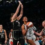 Las Vegas Aces' A'ja Wilson (22) drives to the basket as New York Liberty's Stefanie Dolson (31) and Courtney Vandersloot (22) defends.