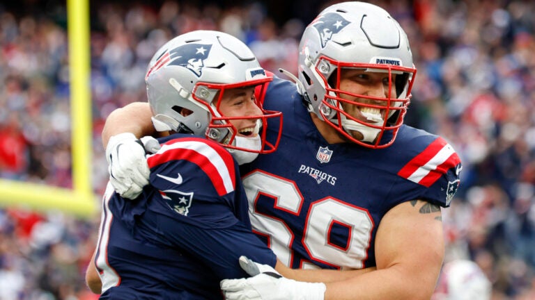 New England Patriots guard Cole Strange (69) hugs quarterback Mac Jones (10) after scoring the go ahead touchdown during the second half of an NFL football game against the Buffalo Bills on Sunday, Oct. 22, 2023, in Foxborough, Mass.