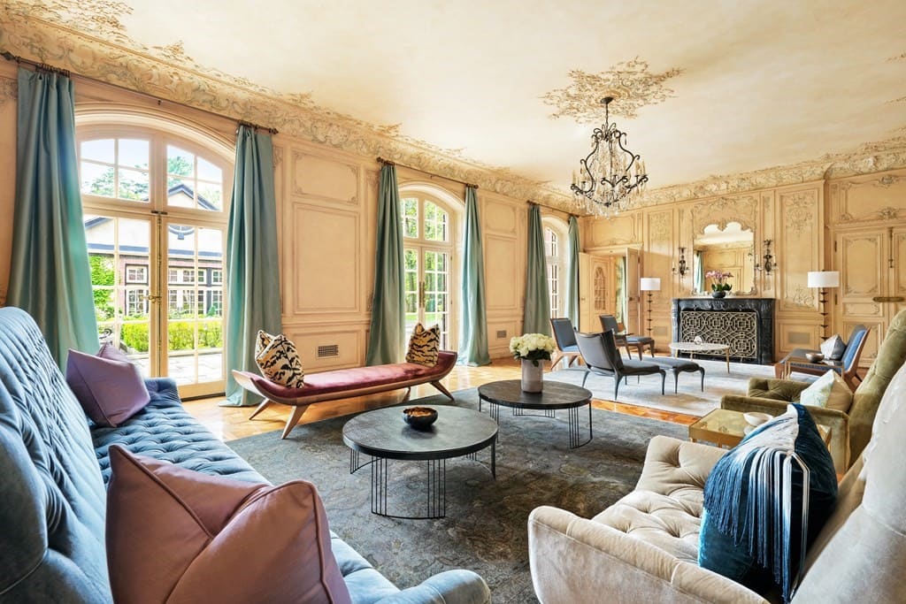 Casual living room with French doors in Brookline home. 