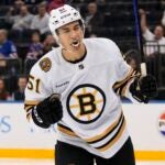 Boston Bruins' Matthew Poitras (51) celebrates after scoring a goal against the New York Rangers during the third period of an NHL preseason hockey game Thursday, Oct. 5, 2023, in New York. The Bruins won 3-1.
