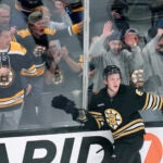 Boston Bruins defenseman Mason Lohrei and fans celebrate his goal against the Washington Capitals during the first period of a preseason NHL hockey game Tuesday, Oct. 3, 2023, in Boston.
