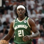 Milwaukee Bucks guard Jrue Holiday moves the ball down the court during the first half of Game 3 in a first-round NBA basketball playoff series against the Miami Heat, April 22, 2023, in Miami. Holiday is being traded to the Boston Celtics, a person with knowledge of the agreement said Sunday, Oct. 1 2023, a move that comes just four days after being sent to the Portland Trail Blazers in the deal that sent Damian Lillard to the Bucks.