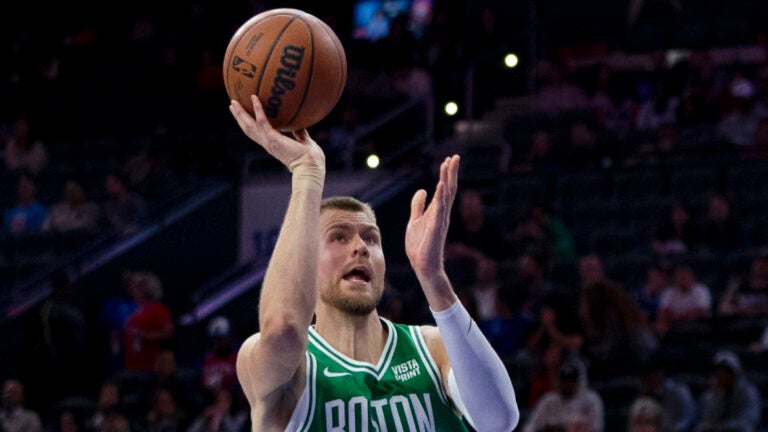Boston Celtics' Kristaps Porzingis shoots over Philadelphia 76ers' P.J. Tucker.