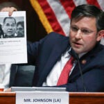 Rep. Mike Johnson, R-La., holds up an article while questioning Attorney General William Barr.