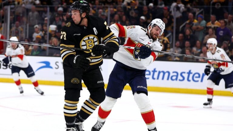 Charlie McAvoy #73 of the Boston Bruins commits an illegal check to the head against Oliver Ekman-Larsson #91 of the Florida Panthers during the third period at TD Garden on October 30, 2023 in Boston, Massachusetts.