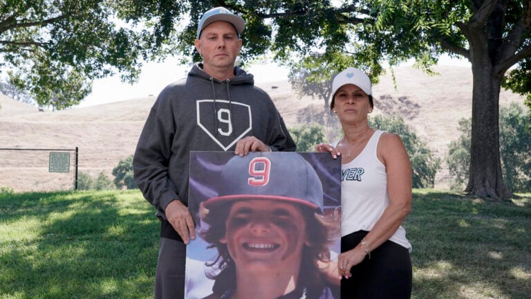 Padrig and Gina Fahey hold a photo of their son, Braden, 12.