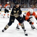 Philadelphia Flyers' Elliot Desnoyers (73) defends against Boston Bruins' Matthew Poitras (51) during the second period of a preseason NHL hockey game, Friday, Sept. 29, 2023, in Boston
