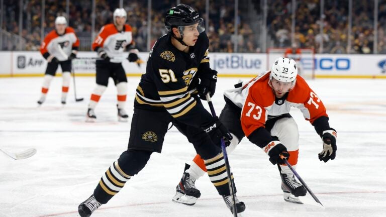 Philadelphia Flyers' Elliot Desnoyers (73) defends against Boston Bruins' Matthew Poitras (51) during the second period of a preseason NHL hockey game, Friday, Sept. 29, 2023, in Boston