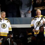 Former Boston Bruins Bobby Orr and Phil Esposito acknowledge the crowd ahead of the Bruins home opener to their 100th Season at TD Garden on October 11, 2023 in Boston, Massachusetts.