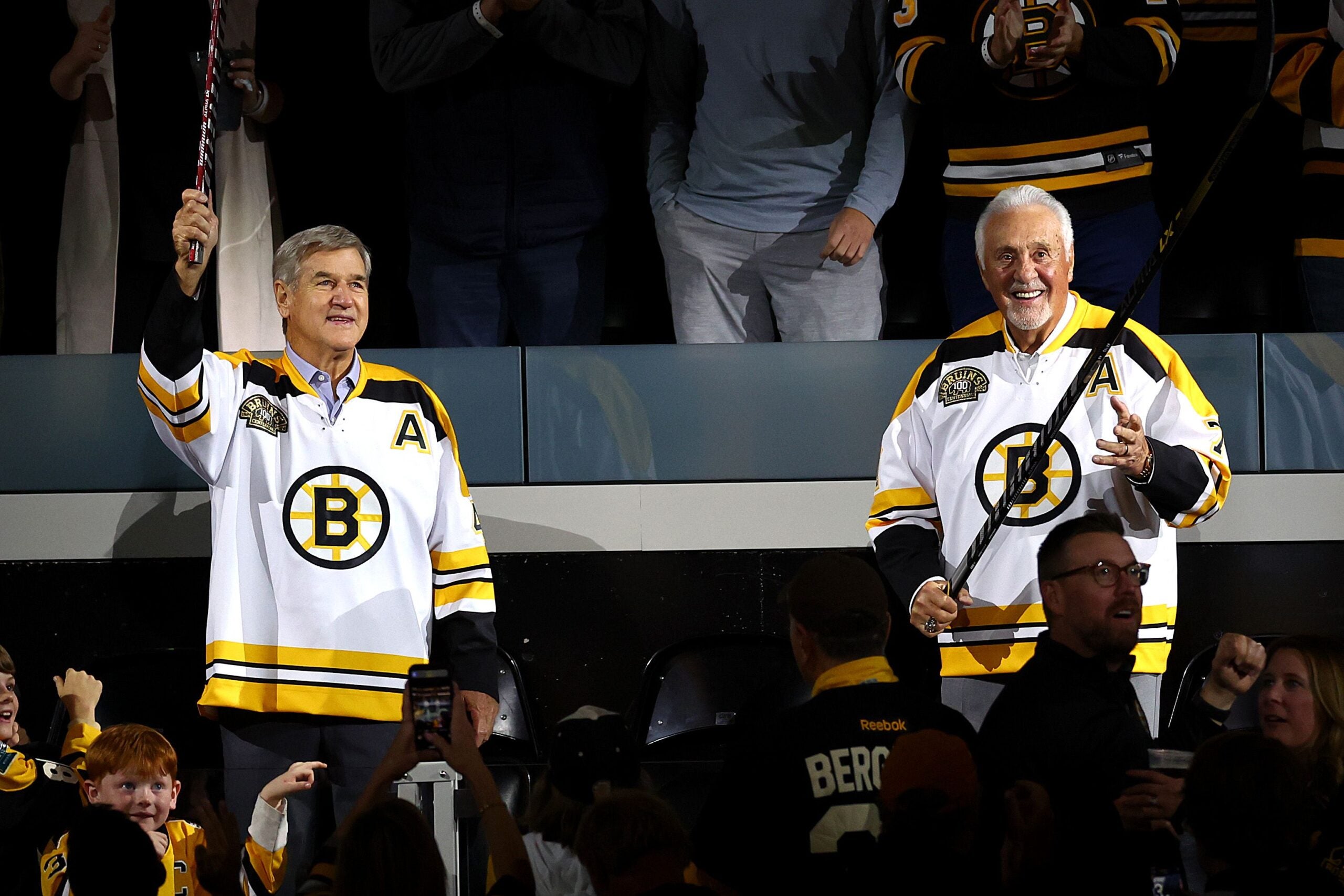 Former Boston Bruins Bobby Orr and Phil Esposito acknowledge the crowd ahead of the Bruins home opener to their 100th Season at TD Garden on October 11, 2023 in Boston, Massachusetts.