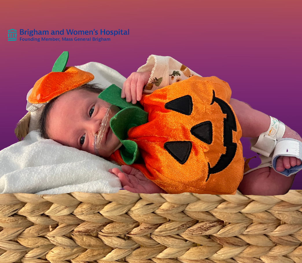 Baby dressed like a pumpkin.