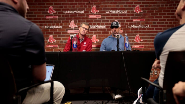 President of the Boston Red Sox Sam Kennedy (L) and Red Sox manager Alex Cora speak to reporters during the Red Sox season-ending press conference.