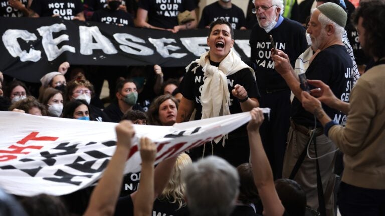 Protesters hold a demonstration in support of a cease fire against the Palestinians in Gaza in the Cannon House Office Building.