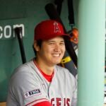Shohei Ohtani #17 of the Los Angeles Angels smiles in the dugout before their game against the Boston Red Sox at Fenway Park on April 16, 2023 in Boston, Massachusetts.