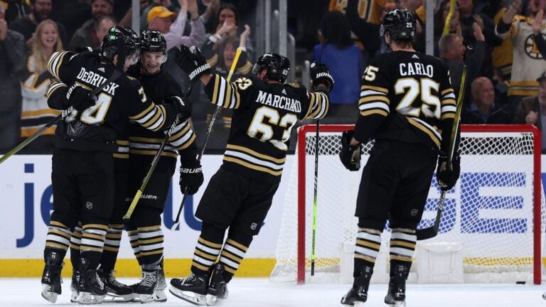 BOSTON, MASSACHUSETTS - OCTOBER 30: Pavel Zacha #18 is surrounded by Jake DeBrusk #74, Danton Heinen #43, and Brad Marchand #63 of the Boston Bruins after scoring the game winning goal during overtime against the Florida Panthers at TD Garden on October 30, 2023 in Boston, Massachusetts. The Bruins defeat the Panthers 3-2.