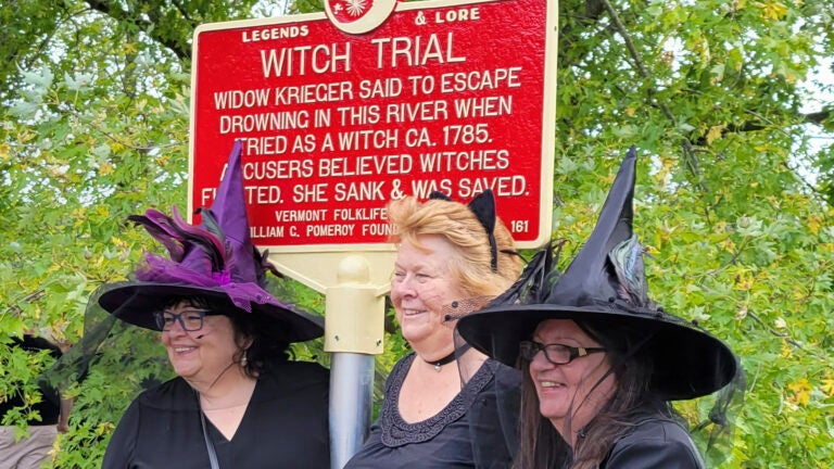 People dressed as witches gather near a newly installed marker, in Pownal, Vt.,