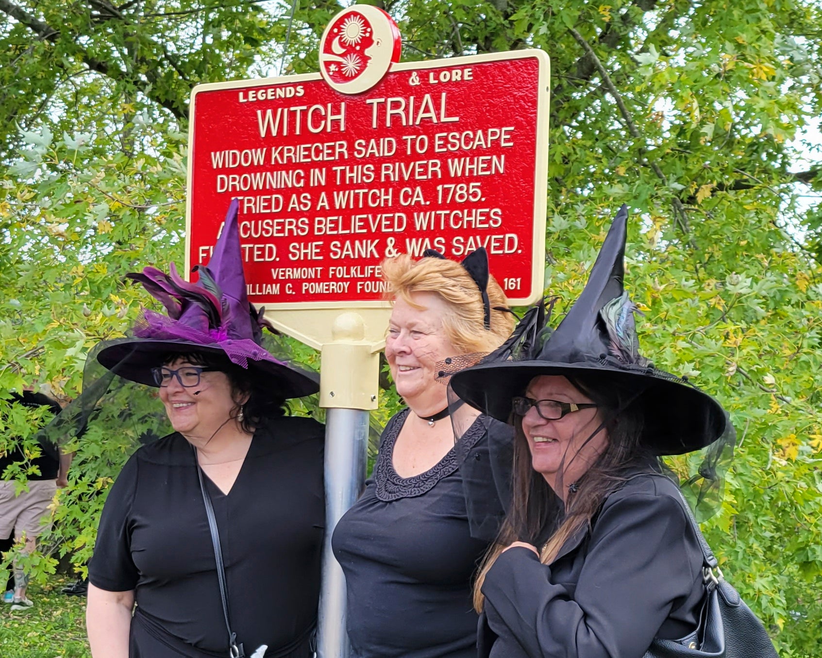 People dressed as witches gather near a newly installed marker, in Pownal, Vt.,