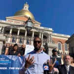 Sean Ellis, 49, of Boston in front of the State House.