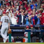 Fans yell as Arizona Diamondbacks starting pitcher Merrill Kelly leaves the game.