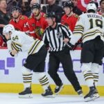 CHICAGO, ILLINOIS - OCTOBER 24: Jakub Lauko #94 of the Boston Bruins reacts after being hit in the eye with a skate by Jason Dickinson #16 of the Chicago Blackhawks (not pictured) during the third period at the United Center on October 24, 2023 in Chicago, Illinois.