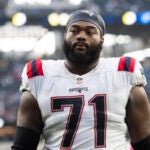 New England Patriots guard Mike Onwenu (71) walks back to the locker room after the team defeats the Los Angeles Chargers in an NFL football game Sunday, Oct. 31, 2021, in Inglewood, Calif.
