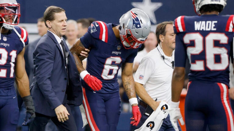 New England Patriots cornerback Christian Gonzalez (6) is escorted off the field after an injury during an NFL Football game against the Dallas Cowboys in Arlington, Texas, Sunday, Nov. 1, 2023.