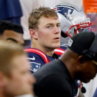 New England Patriots quarterback Mac Jones sits on the bench late in the second half of an NFL football game against the Dallas Cowboys in Arlington, Texas, Sunday, Oct. 1, 2023.