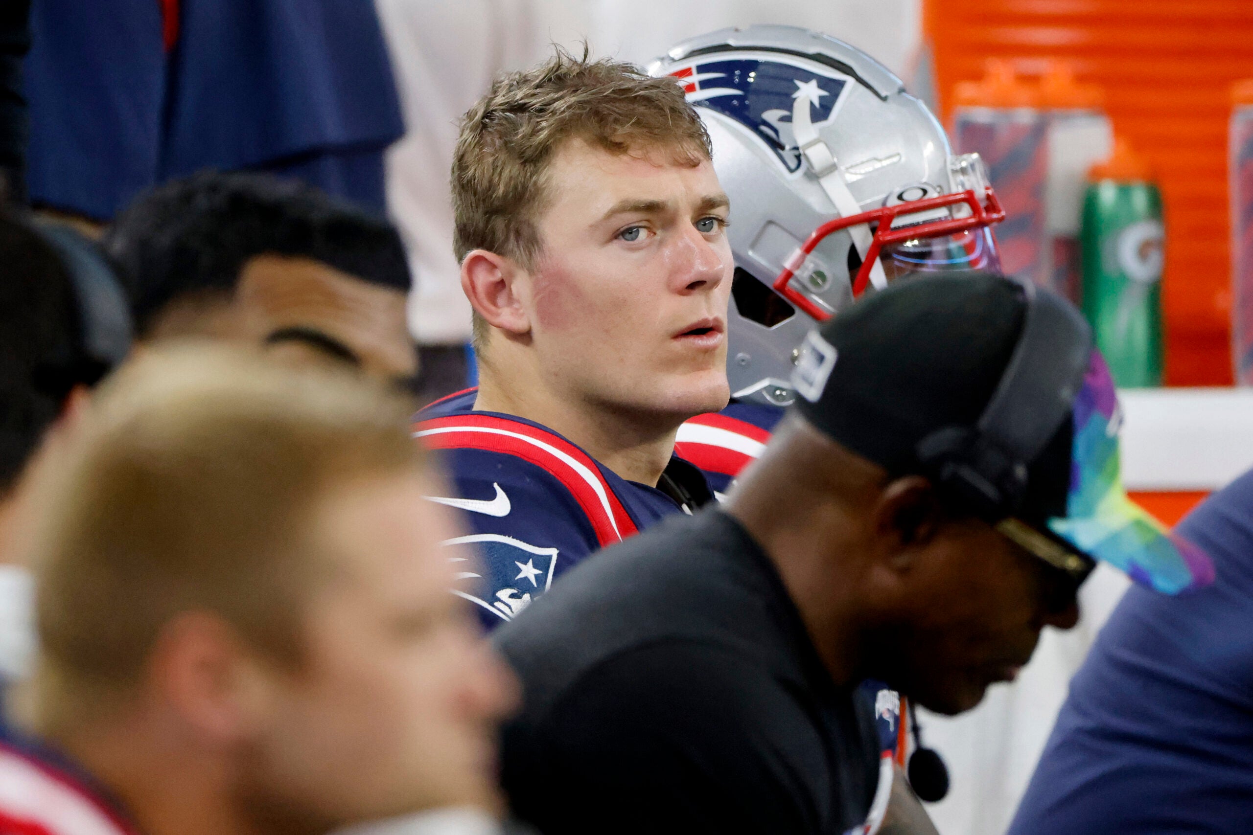 New England Patriots quarterback Mac Jones sits on the bench late in the second half of an NFL football game against the Dallas Cowboys in Arlington, Texas, Sunday, Oct. 1, 2023.
