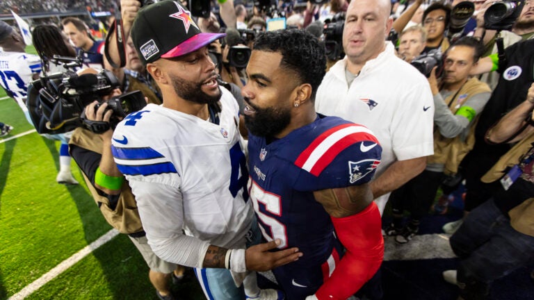 Dallas Cowboys quarterback Dak Prescott (4) and New England Patriots running back Ezekiel Elliott (15) greet each other after an NFL football game, Sunday, Oct. 1, 2023, in Arlington, Texas. Dallas won 38-3