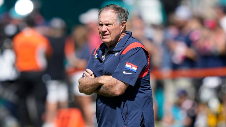 New England Patriots head coach Bill Belichick watches players warm up before the start of an NFL football game against the Miami Dolphins, Monday, Sunday, Oct. 29, 2023 in Miami Gardens, Fla.