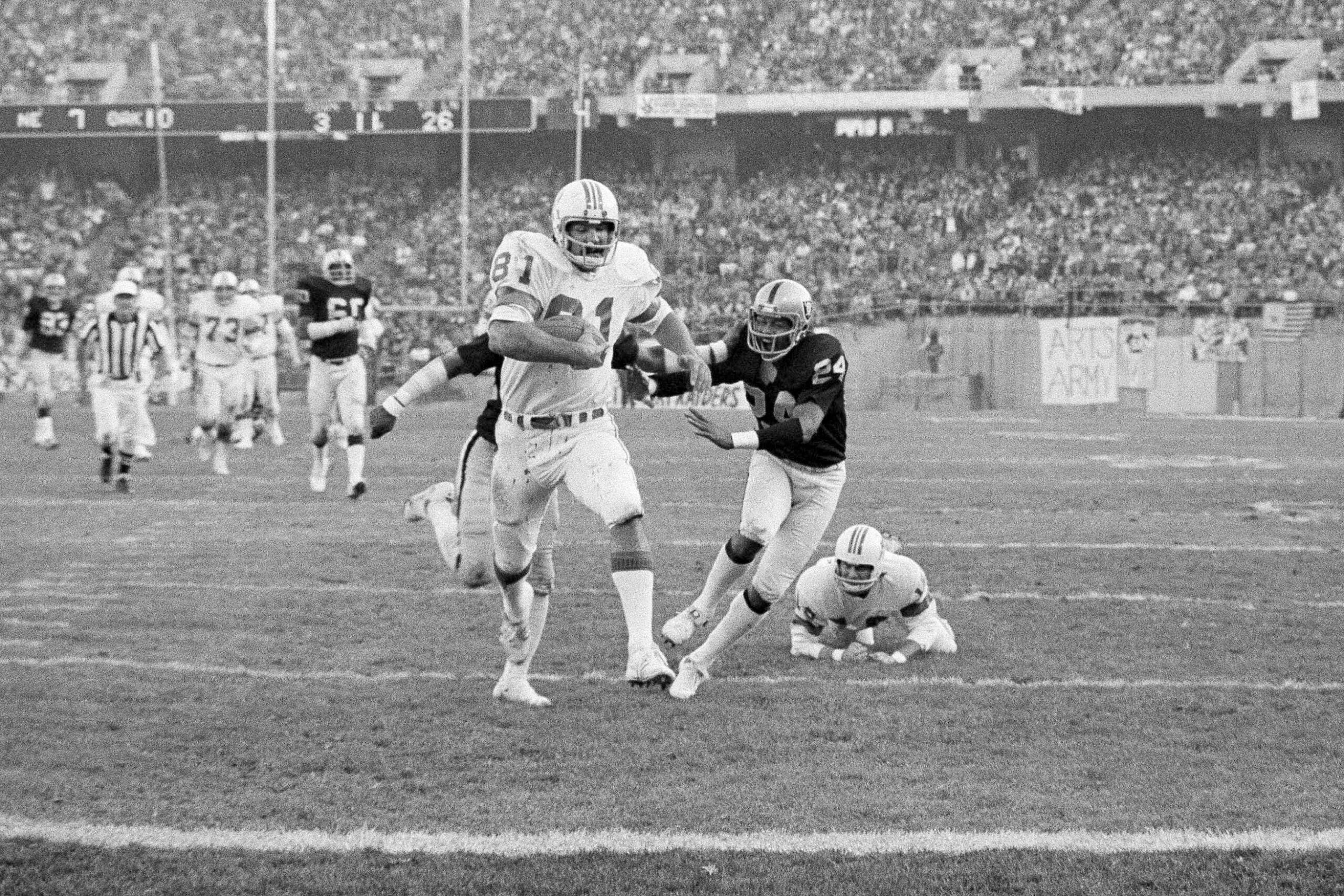 FILE - New England Patriots' Russ Francis carries for a touchdown against the Oakland Raiders during a Dec. 18, 1976 game.