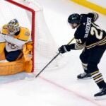 Boston Bruins' James van Riemsdyk (21) scores on Nashville Predators' Juuse Saros during the first period of an NHL hockey game, Saturday, Oct. 14, 2023, in Boston.