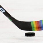 A stick decorated for "Pride Night" with rainbow tape.