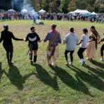 People joined hands during a communal dance at an Indigenous Peoples Day celebration in Newton on Oct. 9, 2023.