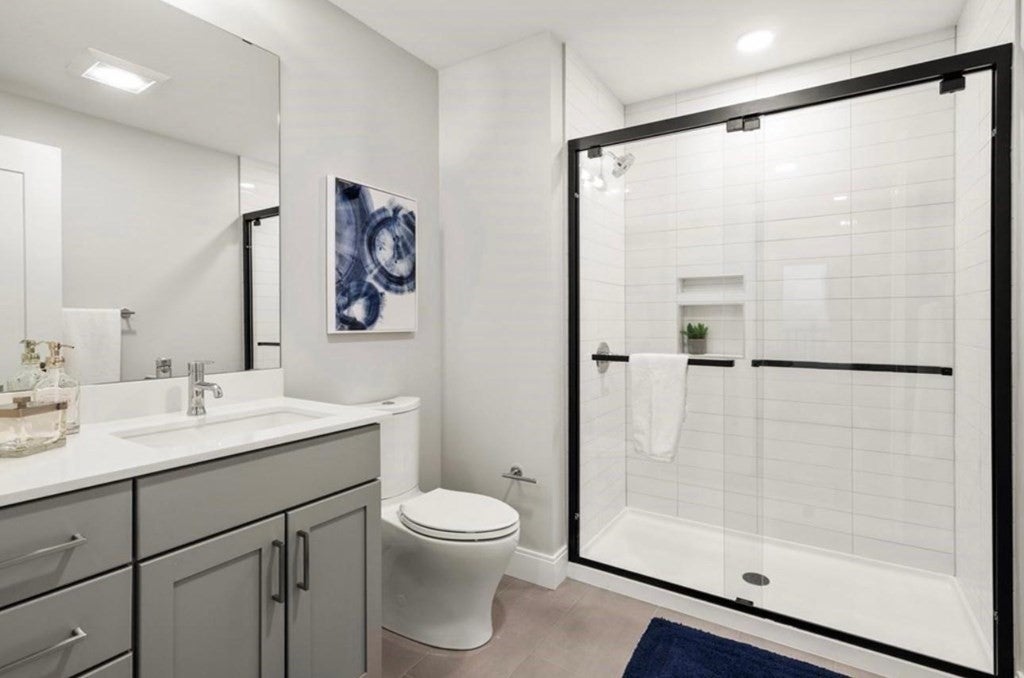 Bathroom in Boston apartment with white tiled shower. 