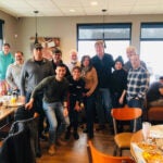 Members of the $1,000 Breakfast Club with their IHOP server.