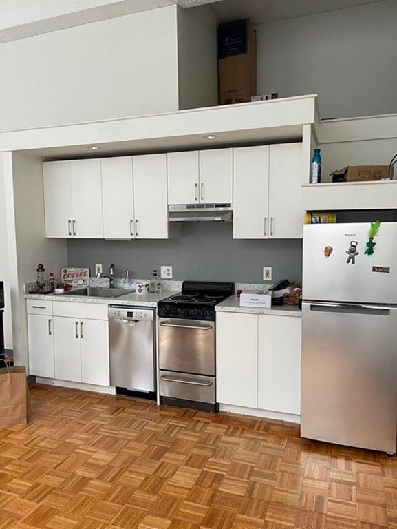 Kitchen with white cabinets in Boston studio