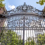 An image of the gates in front of Harvard University's campus.