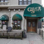 A picture of a building with a green awning that says "Great Scott," a closed music venue in Boston.