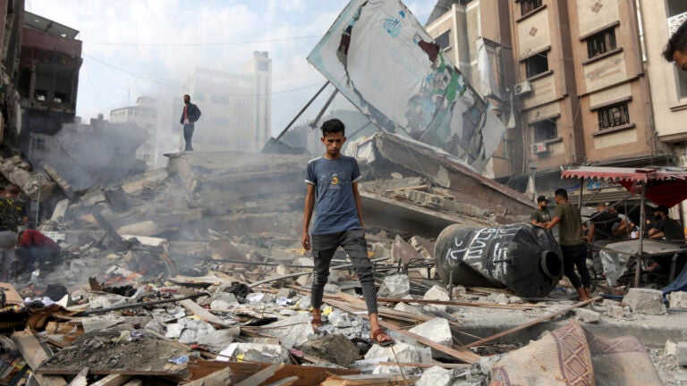 People inspect damage to buildings following Israeli airstrikes in Khan Yunis in Gaza, Oct. 10, 2023.
