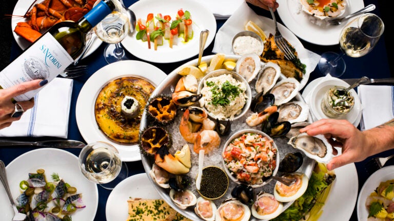 A spread of seafood dishes and raw bar items from Neptune Oyster in Boston's North End.